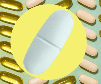 Various pills and capsules arranged on a surface