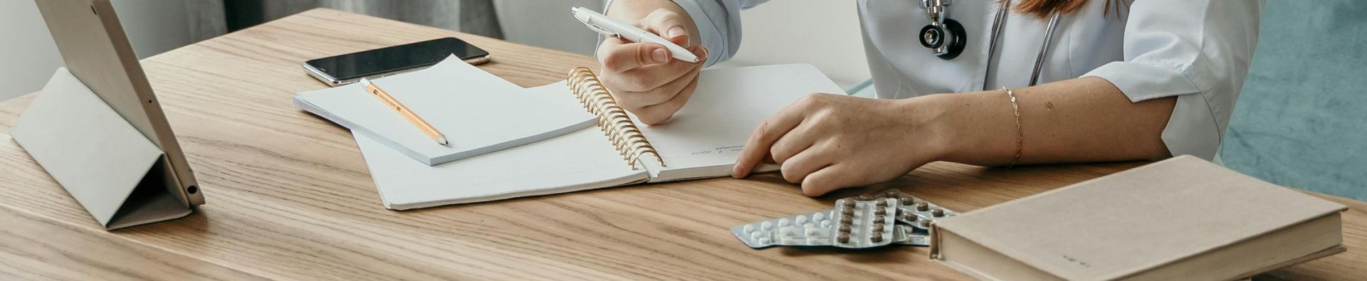 A credentialed pharmacist taking notes while conducting a home medicines review